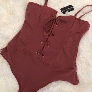 Fashion Nova lace up bodysuit in size medium